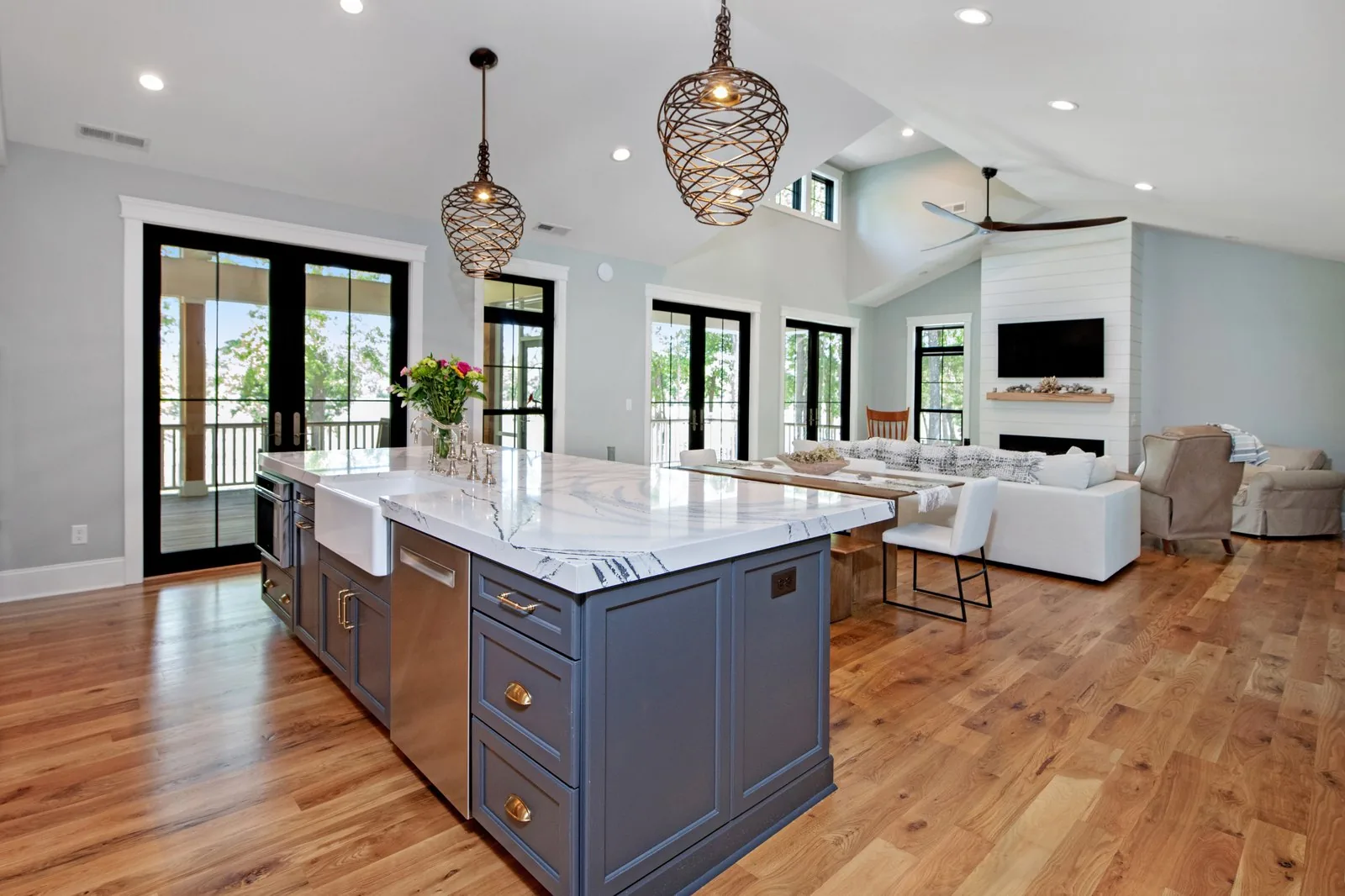 Renovated kitchen with an island and open living space by RMB Building and Design